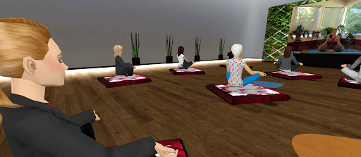 Virtual avatars sit on cushions in a 3D wellness space, watching a guided meditation session on a large screen.
