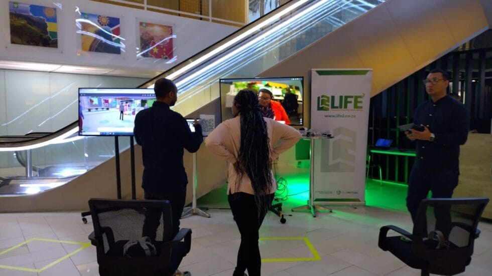 On-site staff demonstrating Old Mutual’s hybrid Metaverse event using the MootUp by Hyperspace platform, linking virtual and physical audiences in real time