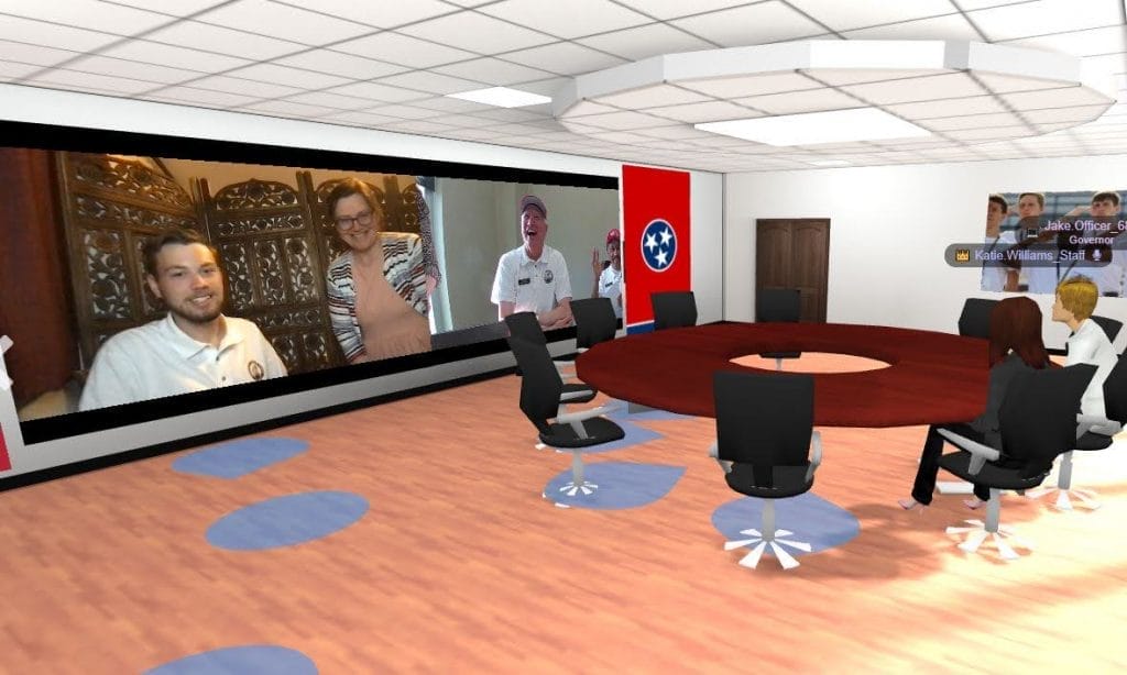 Virtual roundtable session in MootUp by Hyperspace during the Tennessee Boys State hybrid event, with avatars seated around a table and live video feeds of remote participants on a large screen.
